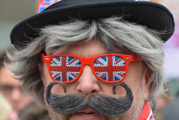 Man decked in union jack hat and spectacles to illustrate blog post Land of Hope and Curry - What does My Book Title Mean? by Yang-May Ooi @TigerSpiritUK